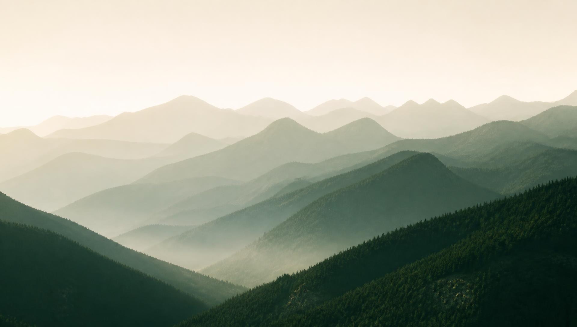 Layered Colorado mountain ridgelines in morning haze